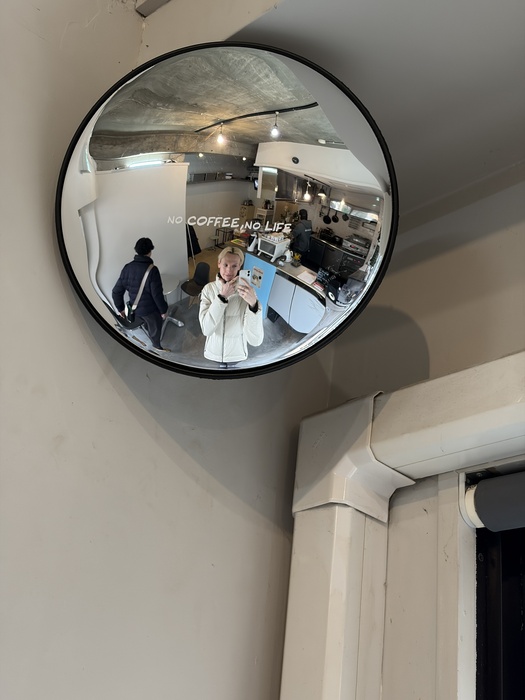 the author reflected in a mirror inside the shop